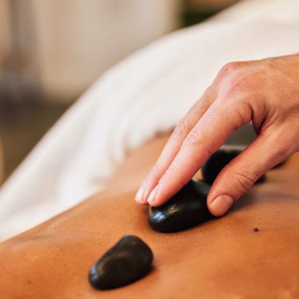 Hot stone massage, spa and skincare for wellness, health and physical therapy to relax in luxury. M.